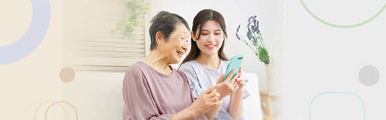 Young lady guiding grandmother with online transactions
