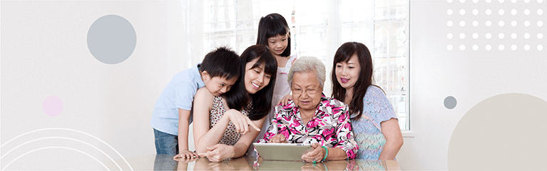 3 generation family looking at iPad