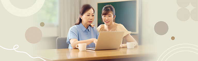 Mother and daughter looking at laptop
