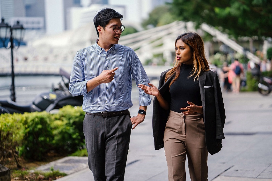 Young adults discussing while walking