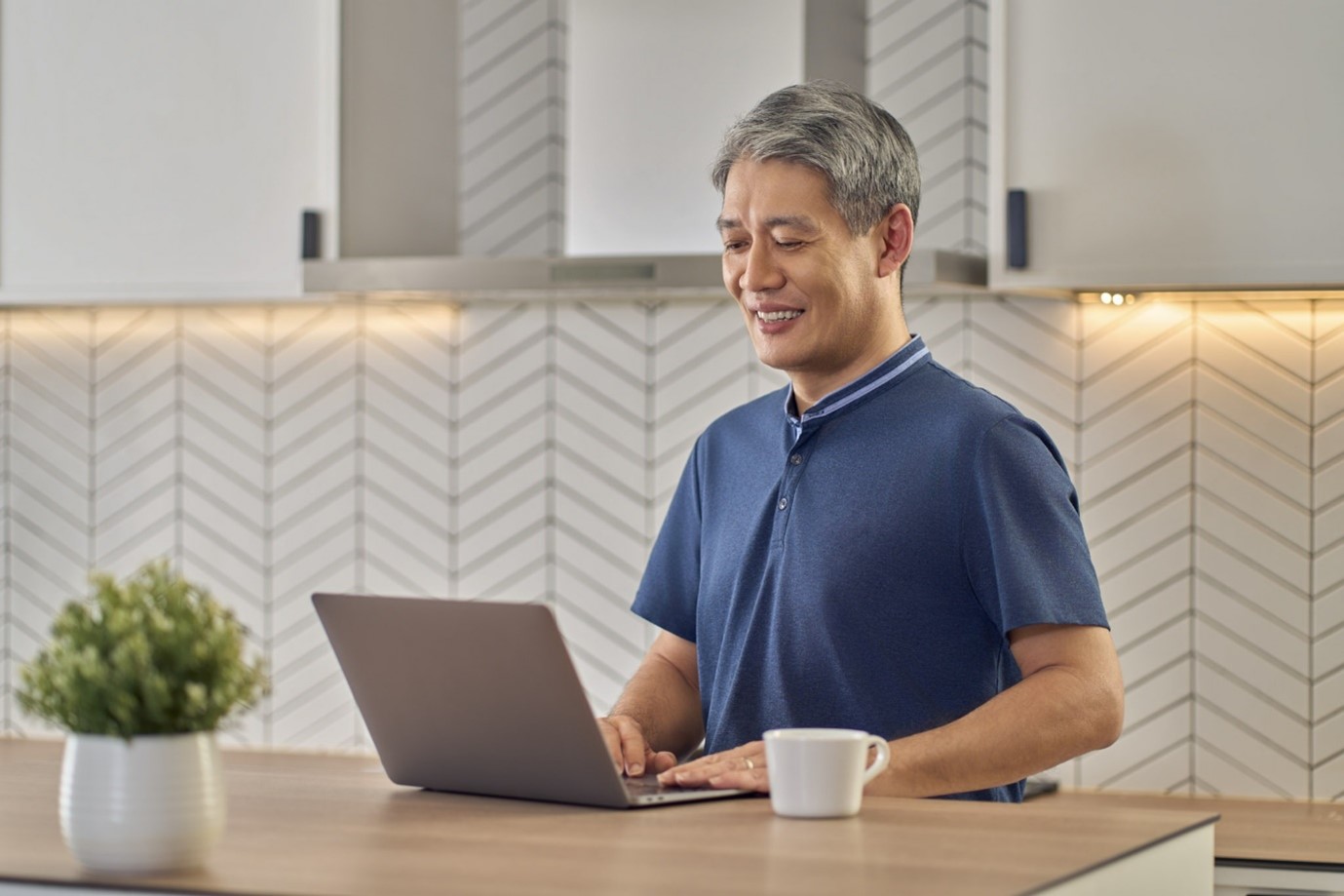 Senior man using a computer at home