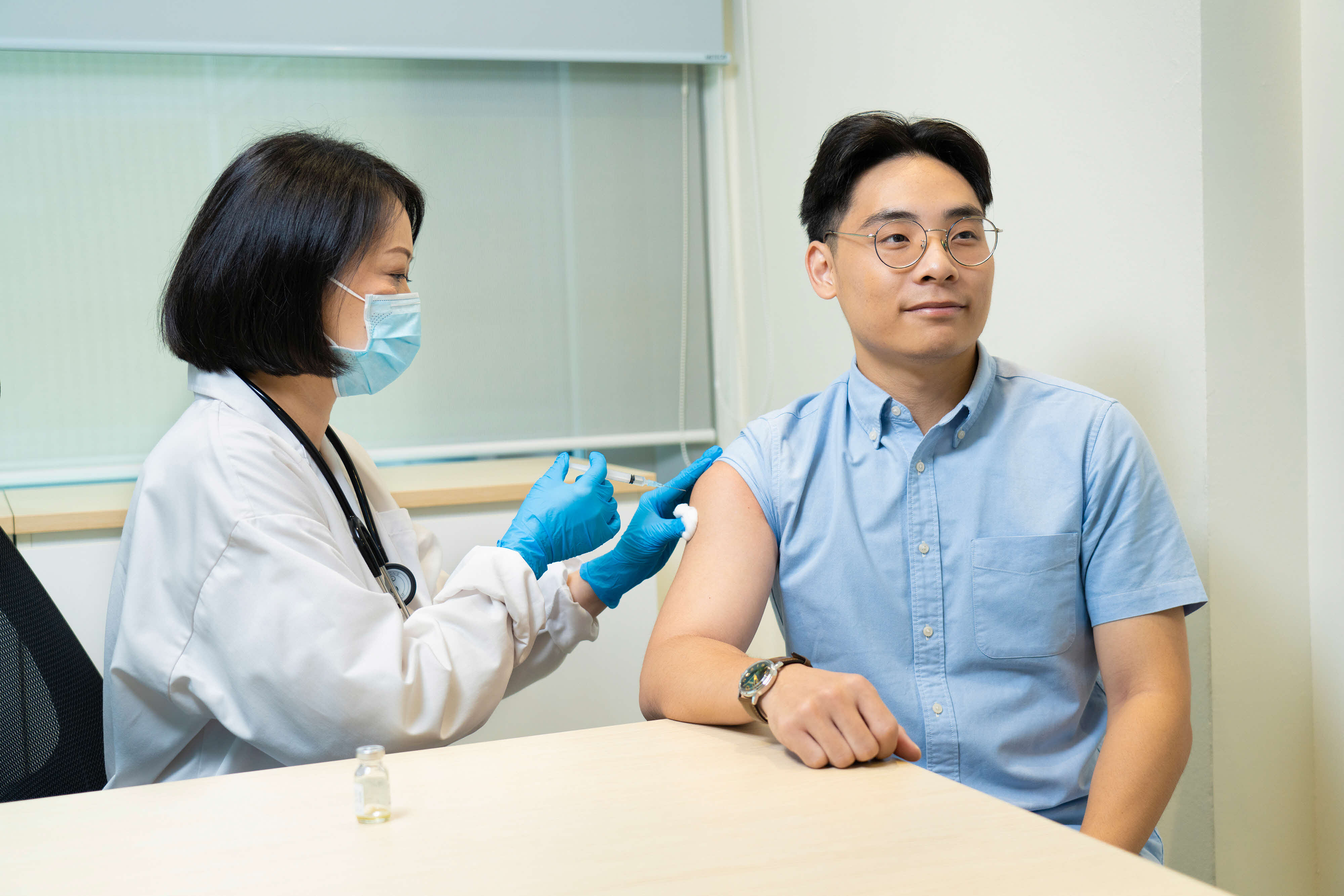 young man getting an injection from the doctor