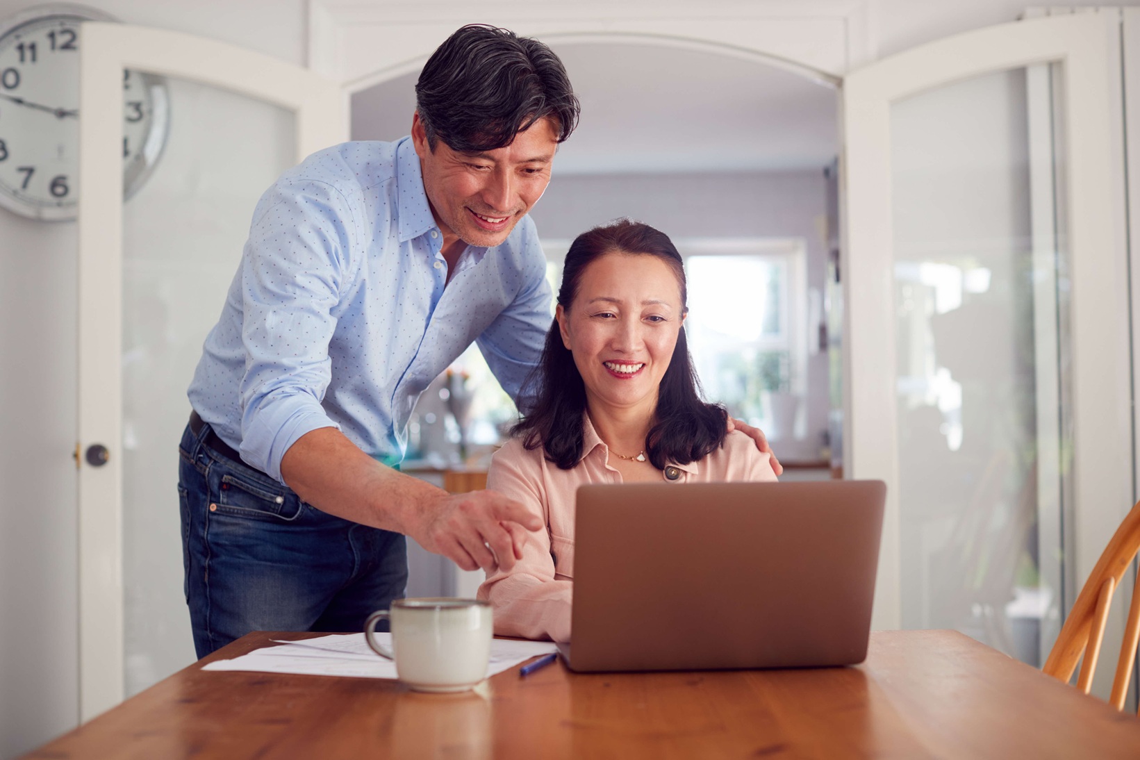 middle aged man and woman looking at a laptop