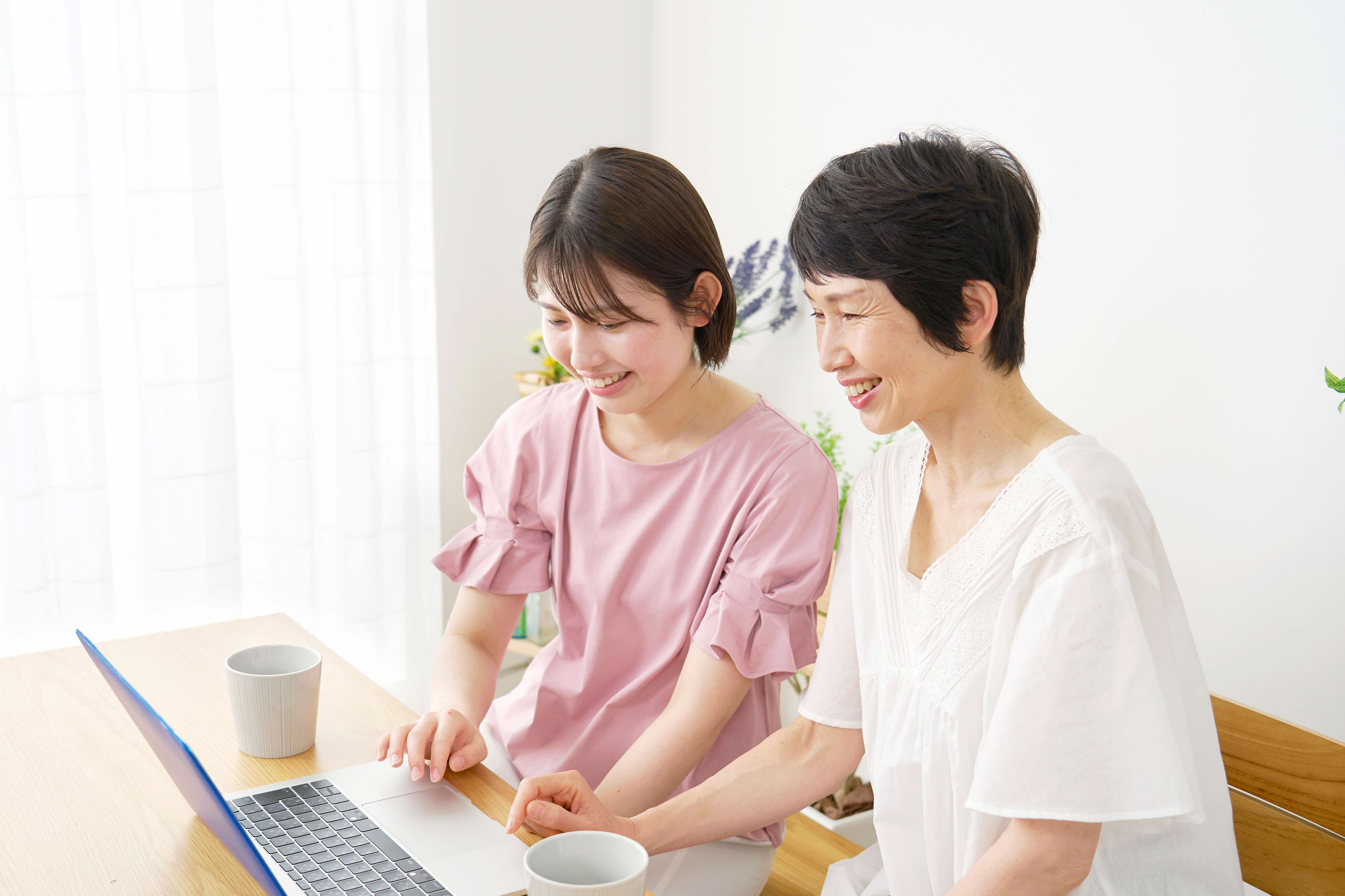 Mother and daughter using the laptop