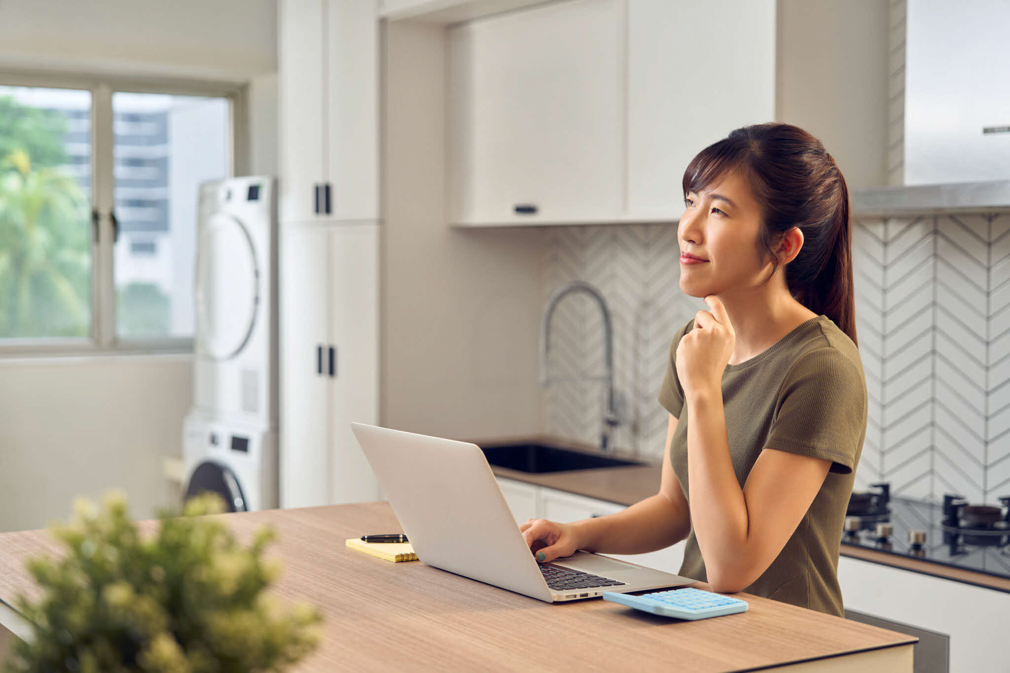 young lady working on her laptop, wondering what's next