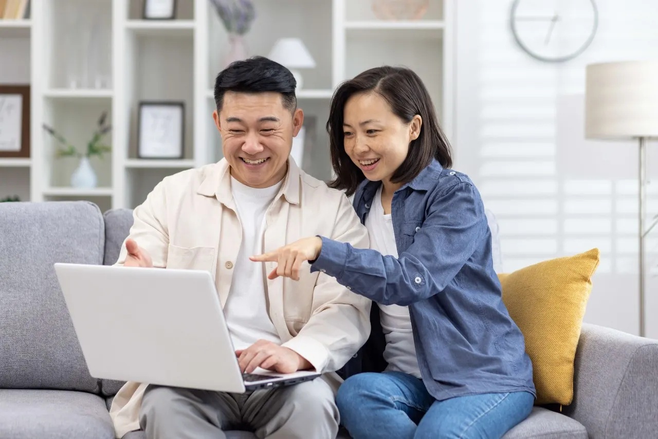 man and woman looking at computer