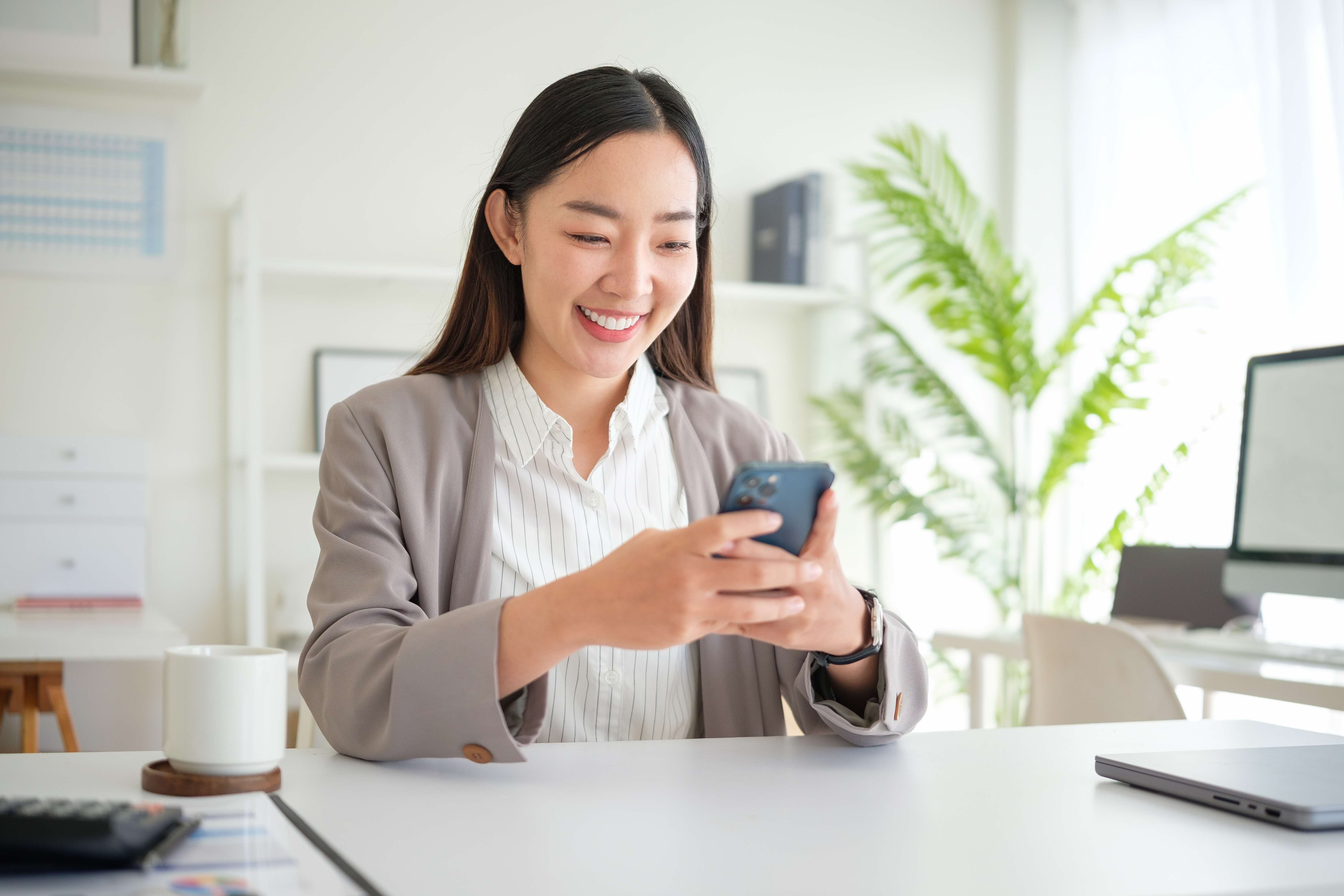 Woman smiling at mobile phone