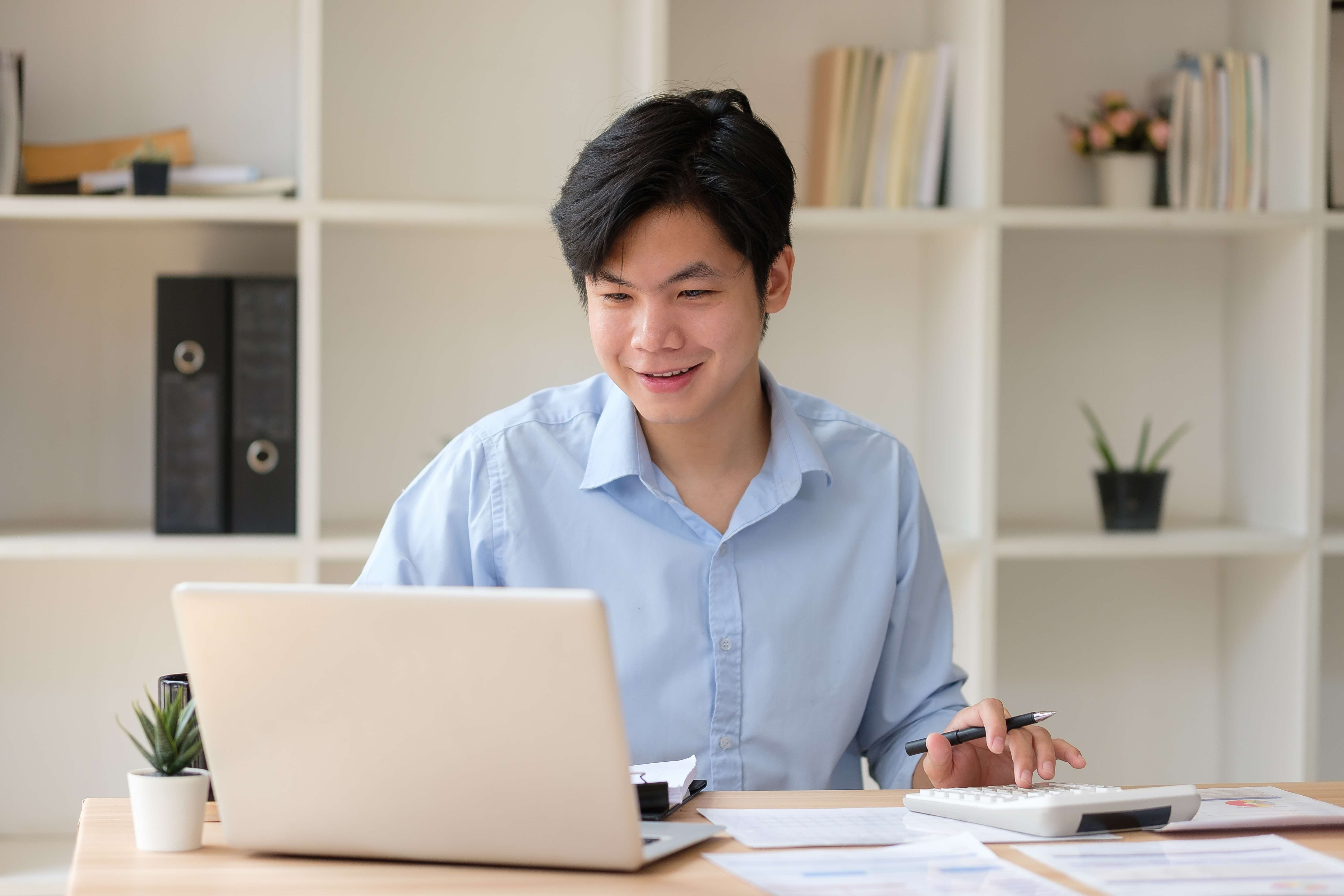 man looking at laptop on investment