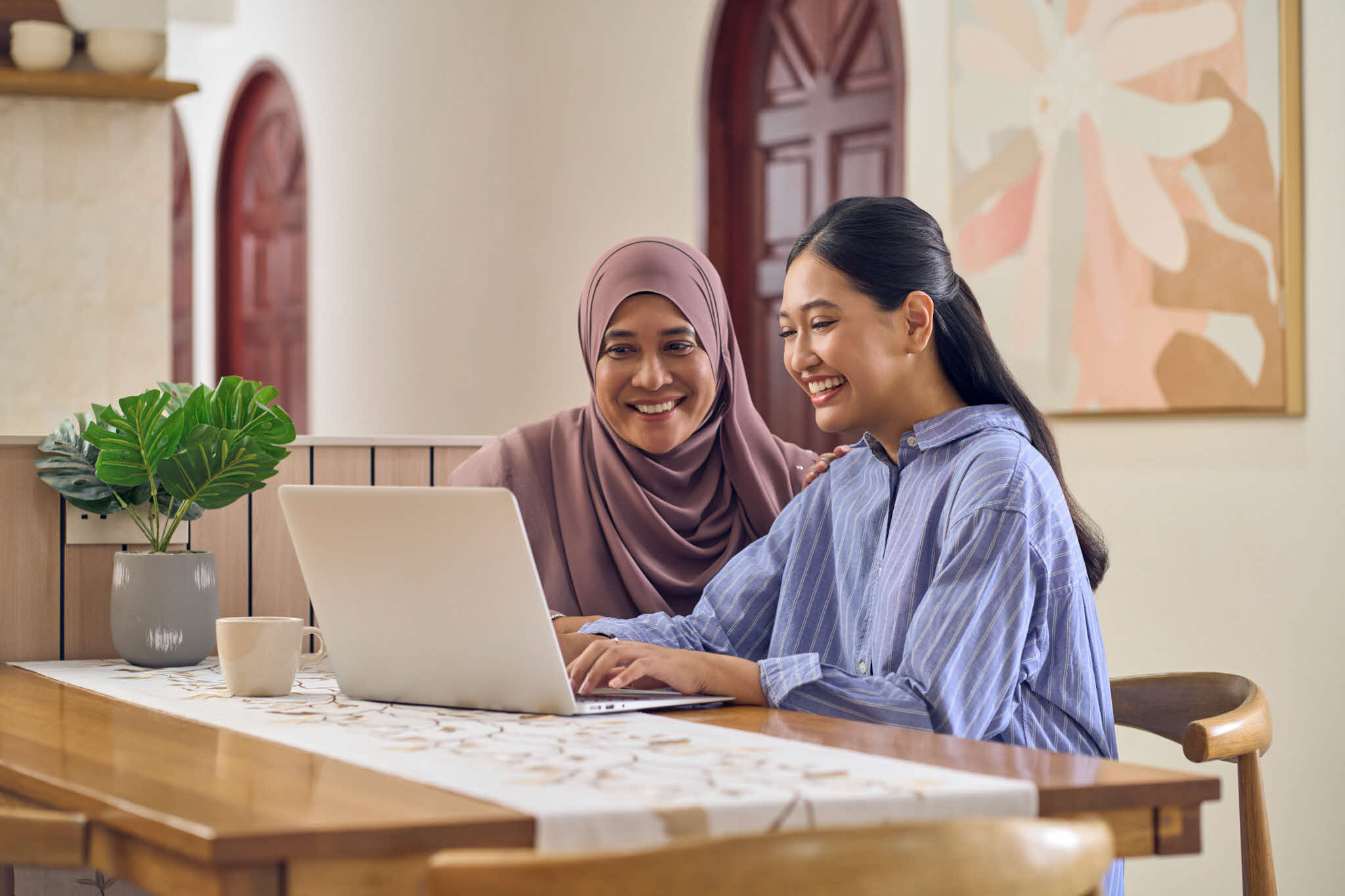 Mother and daughter using the laptop