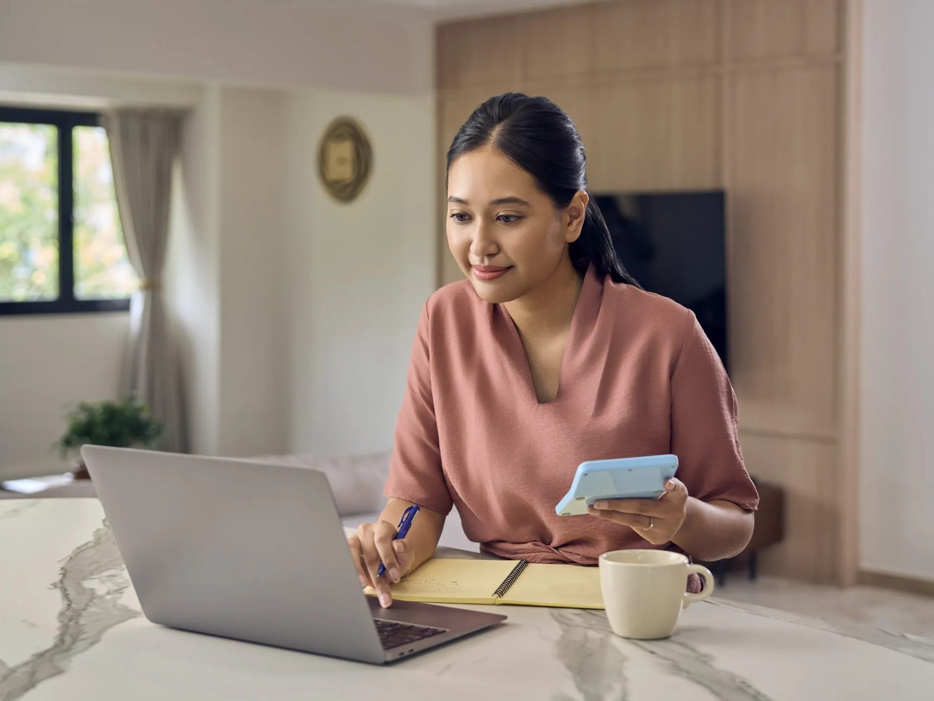 Young lady using her laptop whilst planning