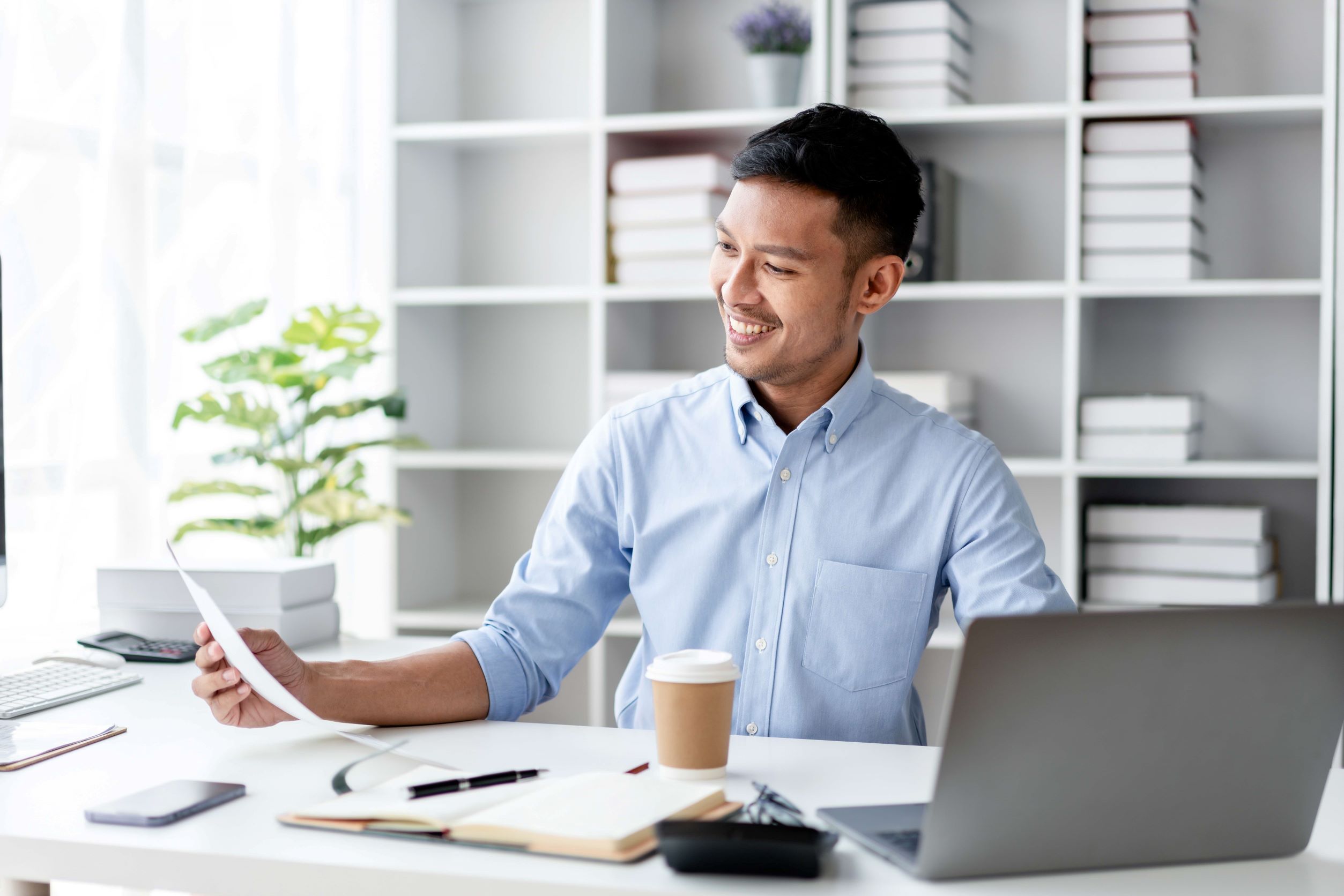 Man looking at document, smiling