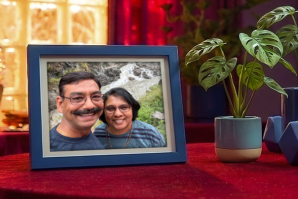 A photo frame of an Indian man and his wife