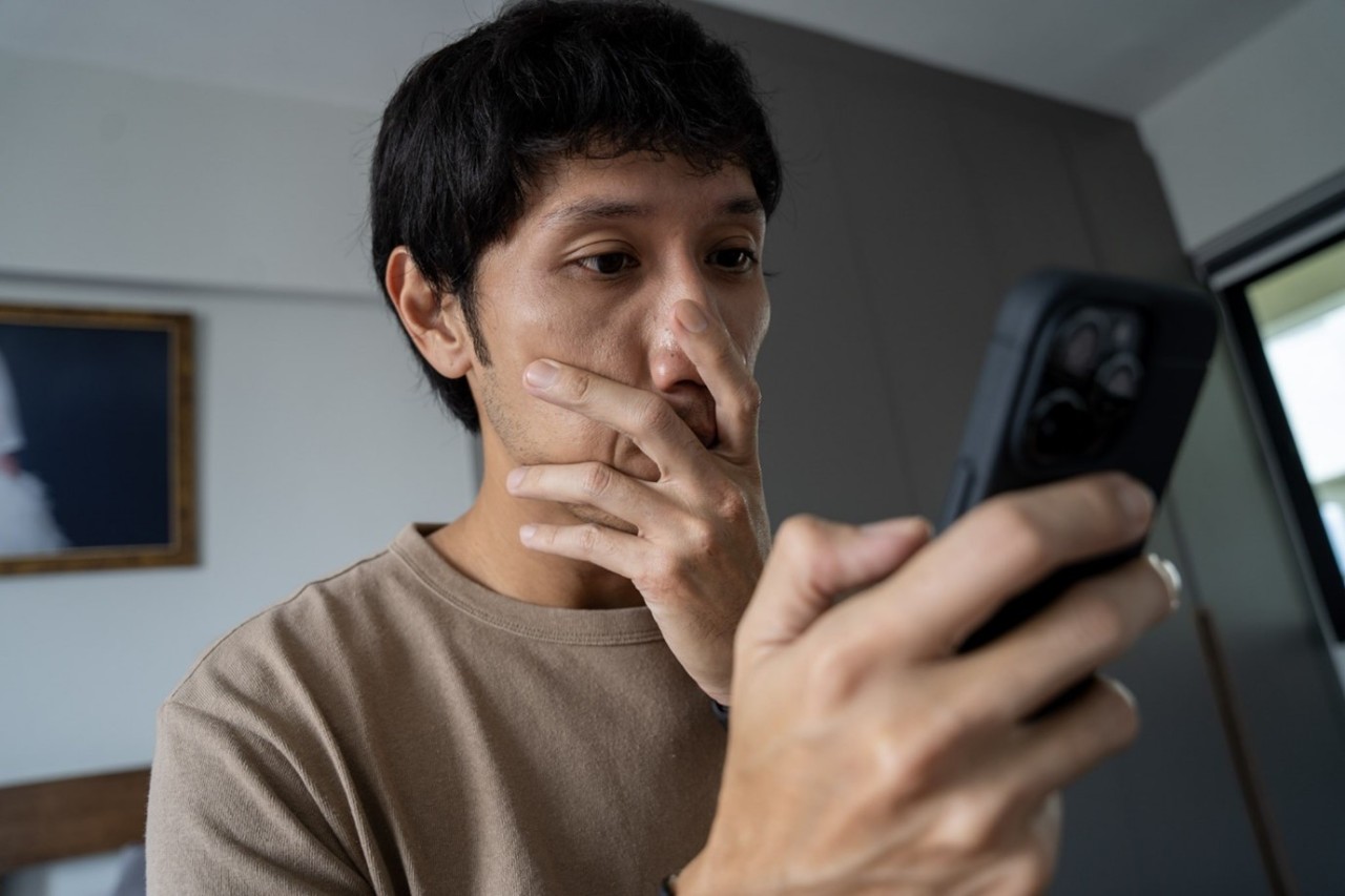 man with a shocked look on his face after being scammed