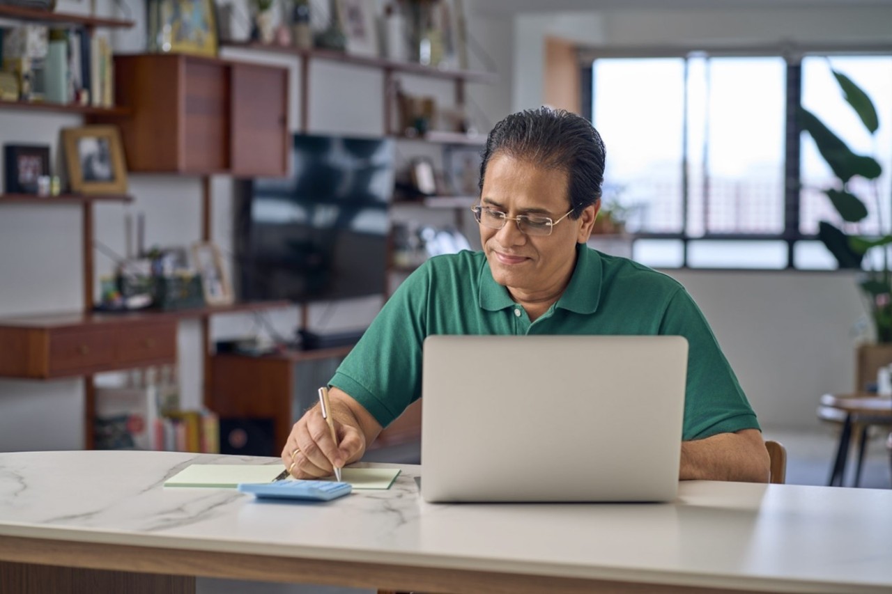 Man looking at his laptop and planning for his finances