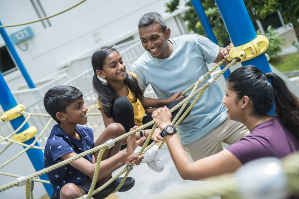 Family enjoying themselves in the playground