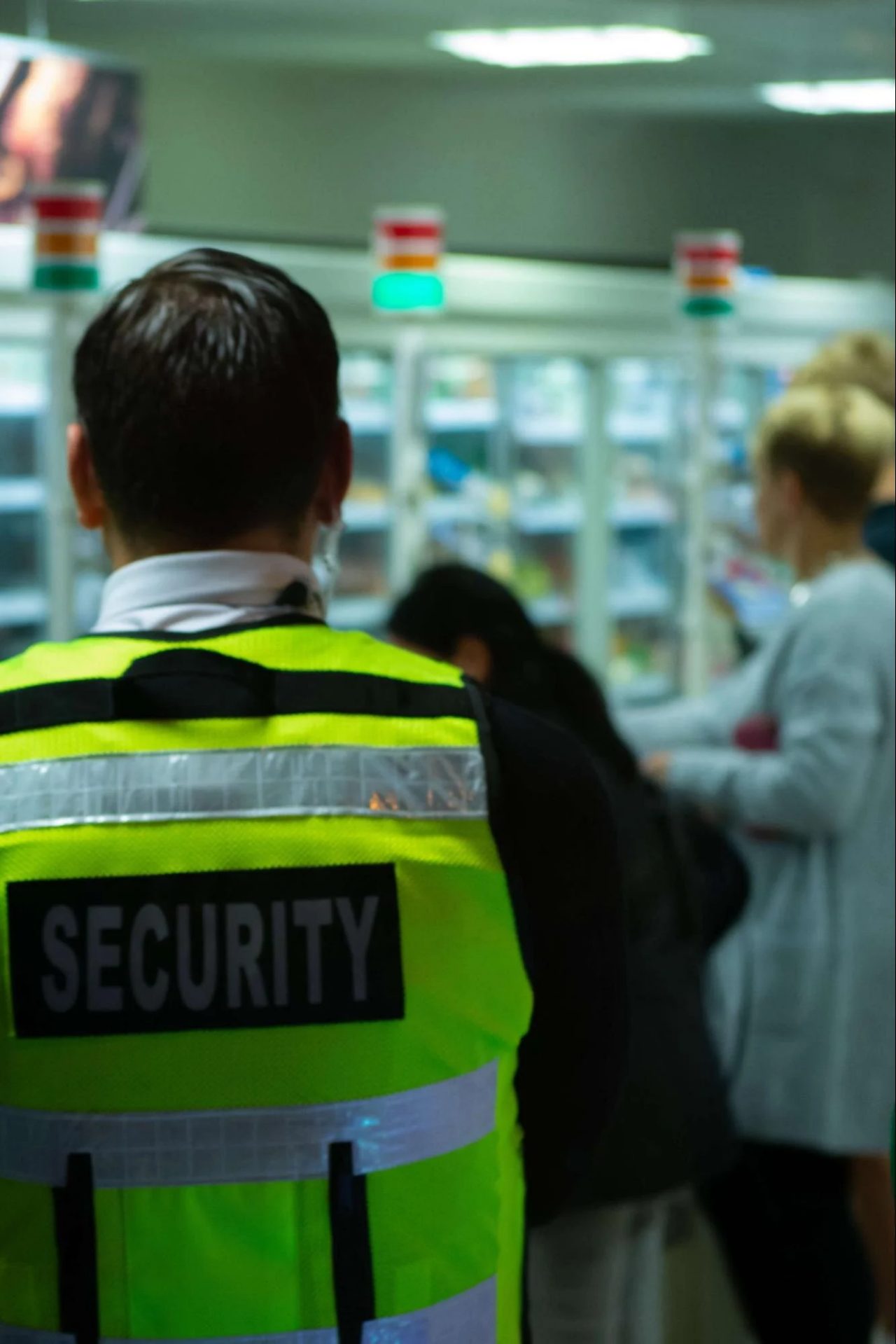 Man standing in a store wearing security vest
