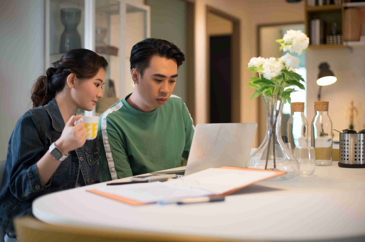 Young couple looking at a laptop 