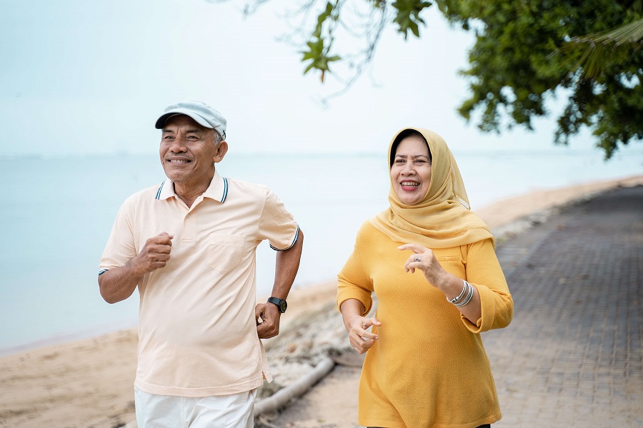 Couple exercising by the beach