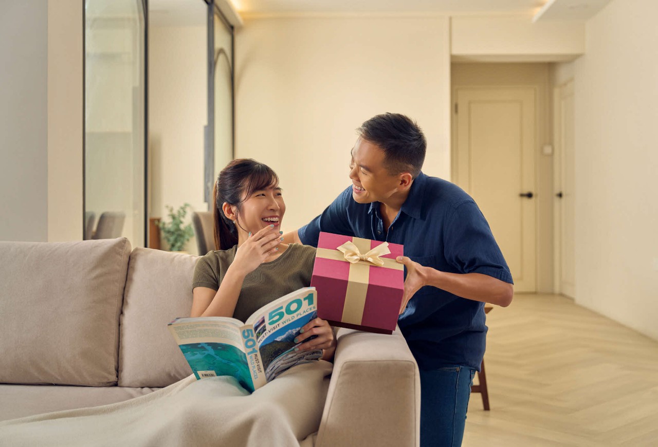 husband surprising his wife with a gift