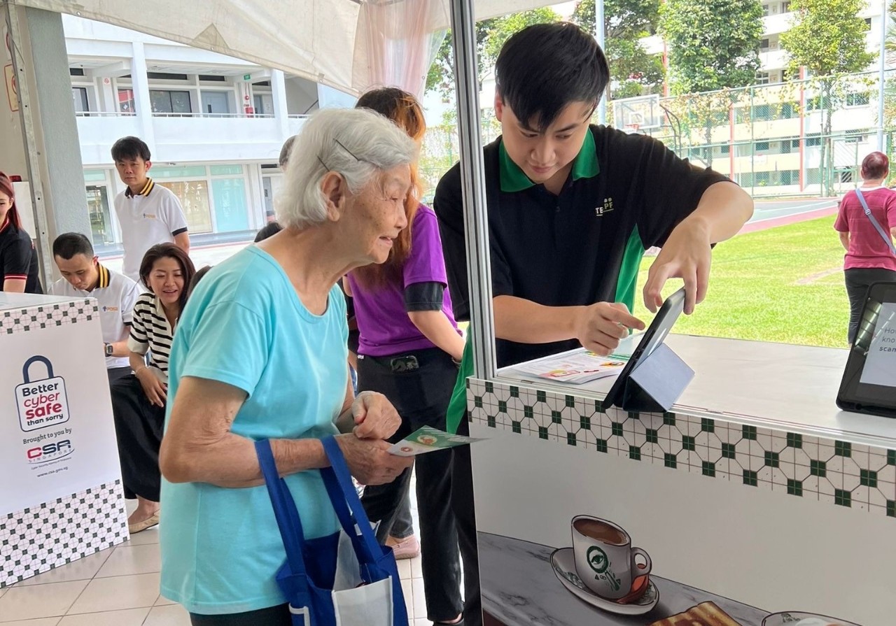 Be Cyber Safe Workshop for Seniors – another anti-scam team member, Samuel Chong, seen explaining the CPF Withdrawal Lock to a senior