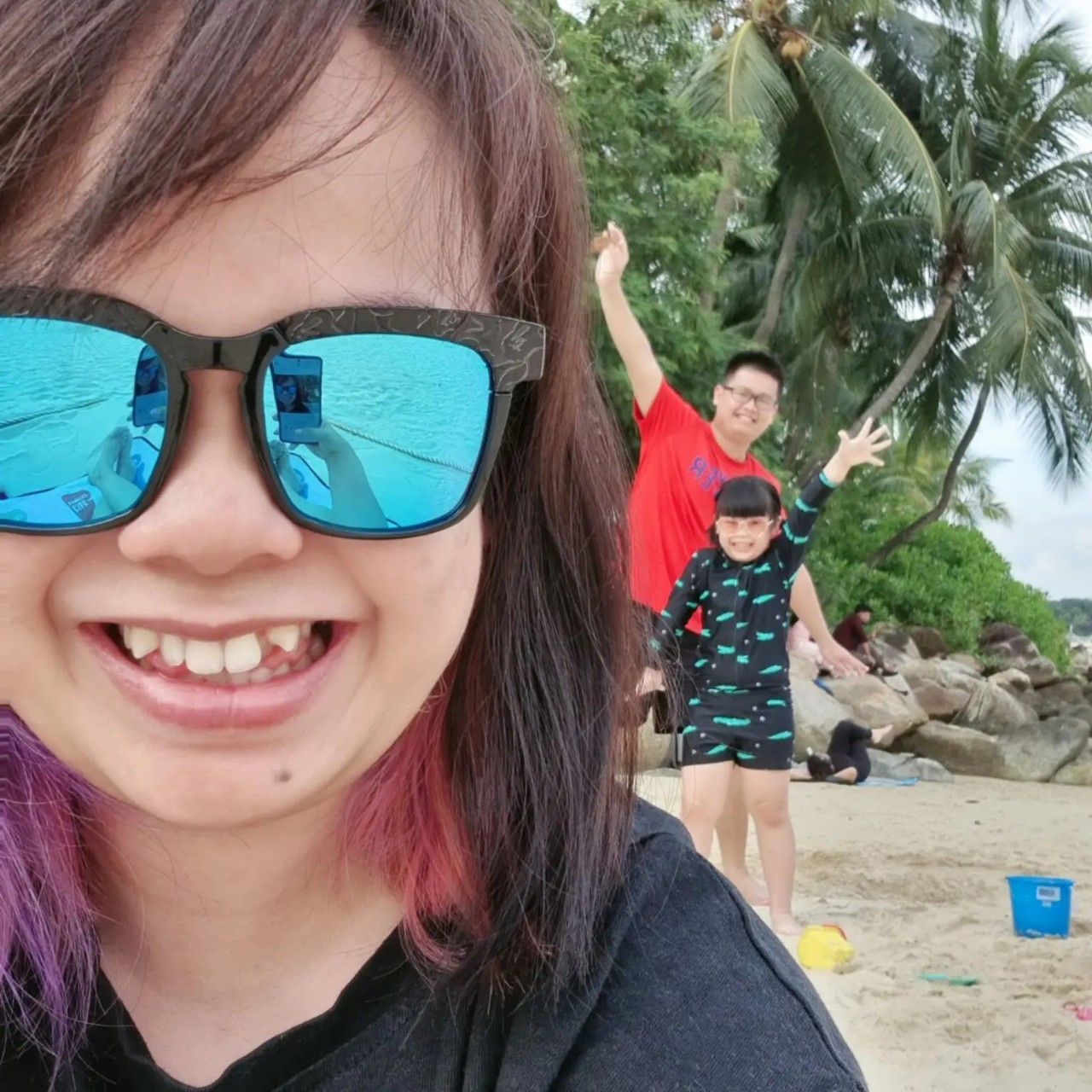 Yee Ting with her husband and daughter at the beach. 