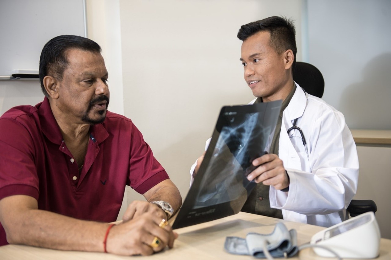 A doctor showing scans to his patient