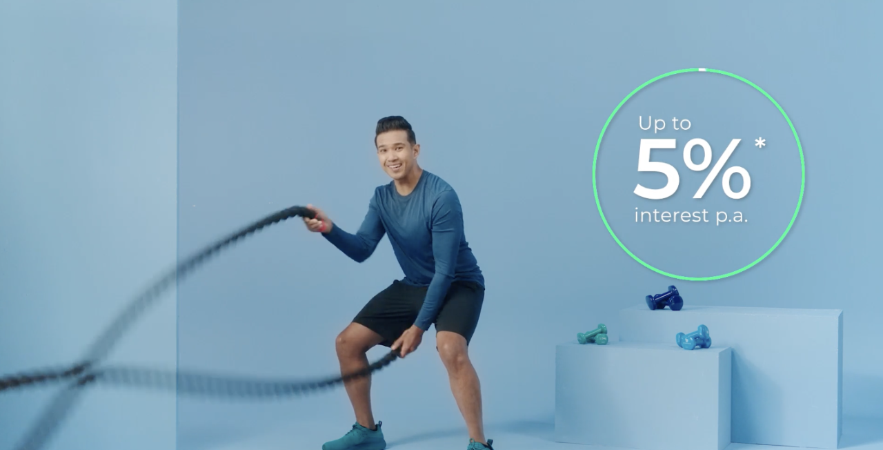Radio personality Shaun Tupaz doing battle ropes to represent CPF savings can grow steadily with interest rate of up to 5% per annum.