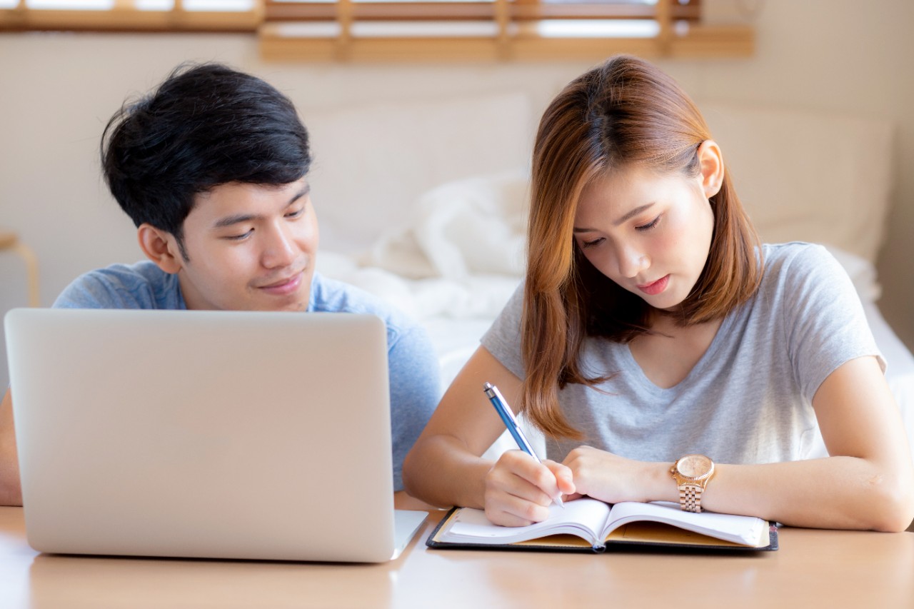 asian couple calculate expenses finance