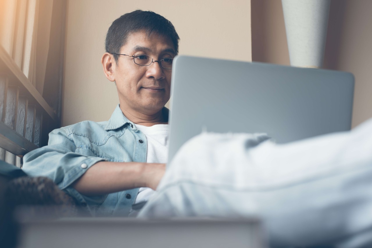 Man using his laptop for healthcare planning