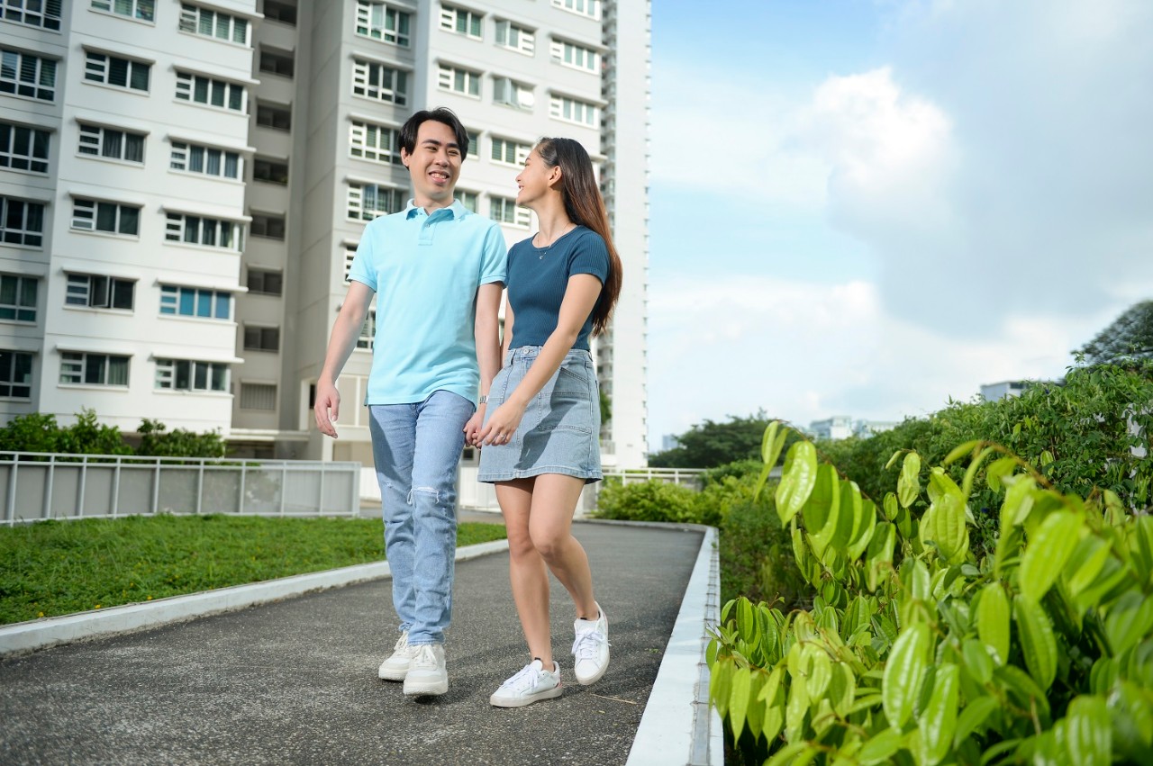 young couple walking around their HDB estate