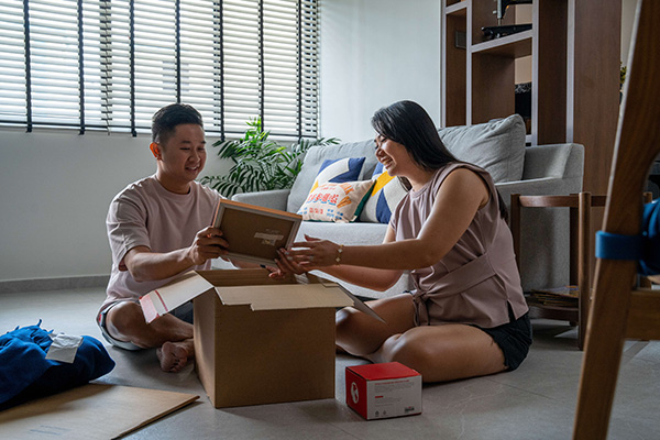 husband and wife unpacking for their new home