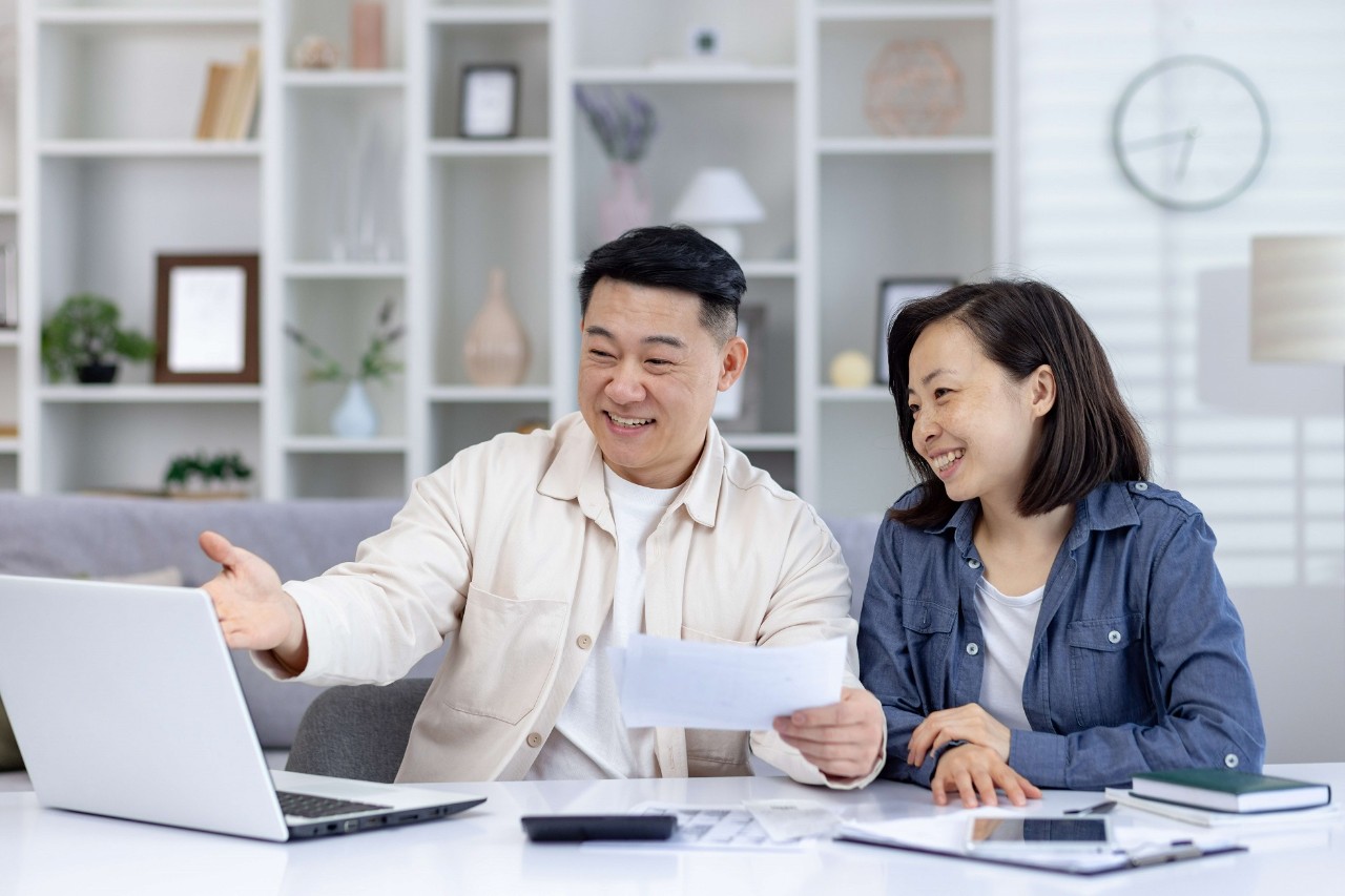 a man and woman infront of laptop