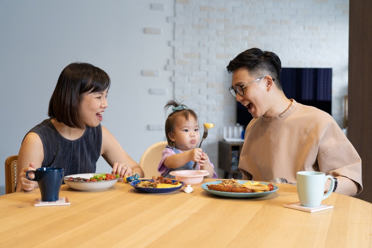 family of three having a meal together