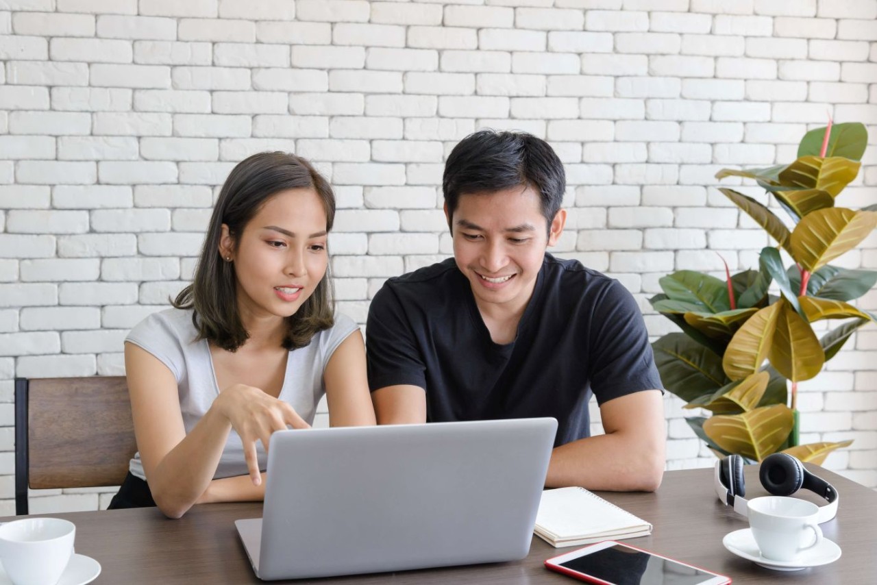 A couple looking at their laptop at home