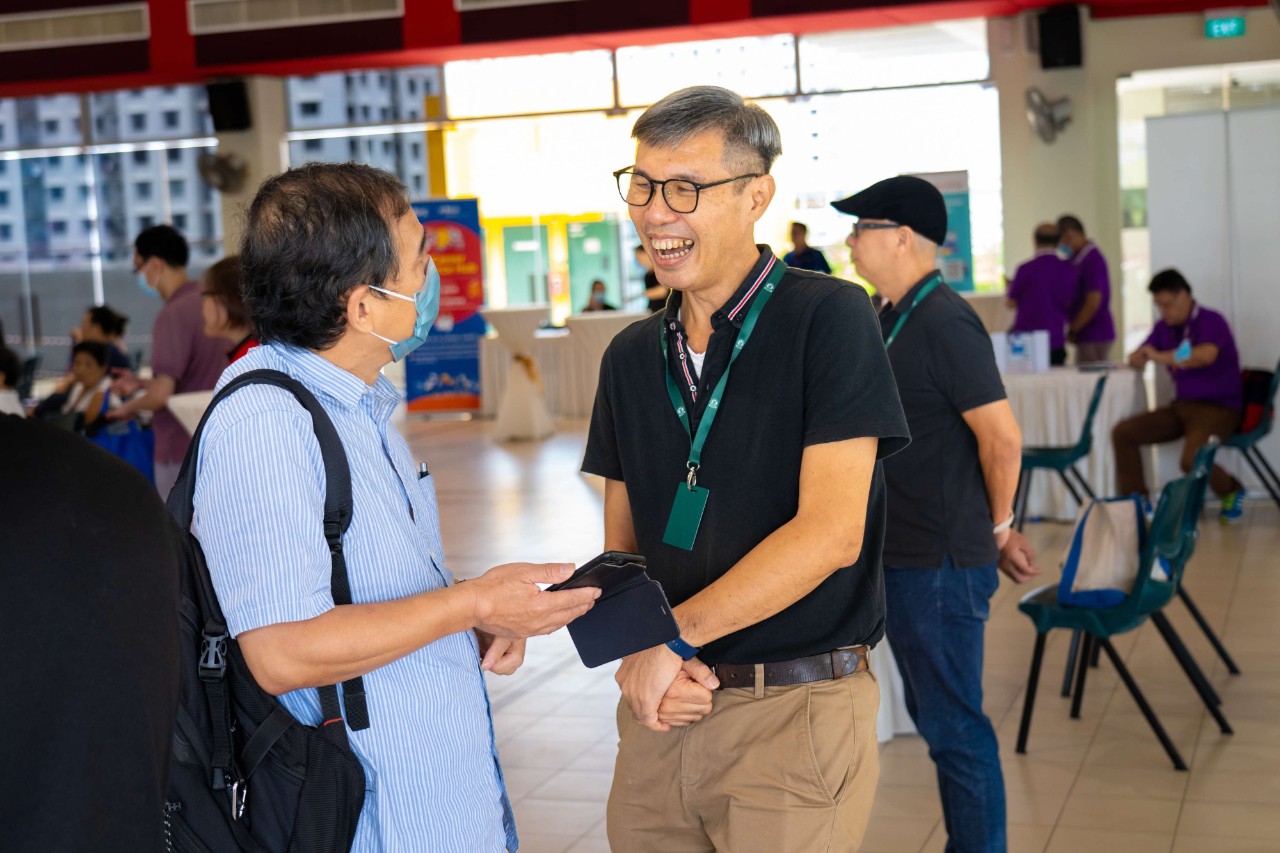 Wai Chung having a conversation with a member of the public