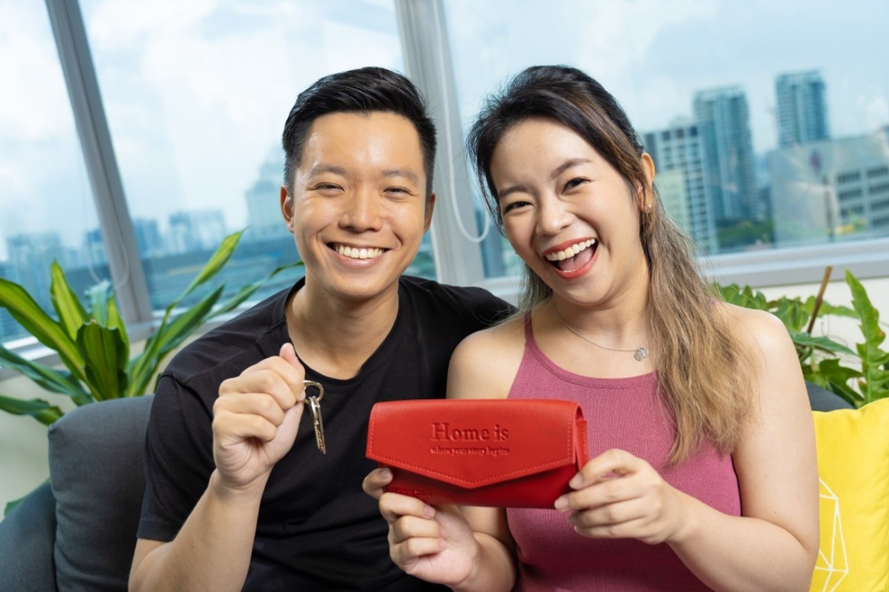 Young couple with their new home keys