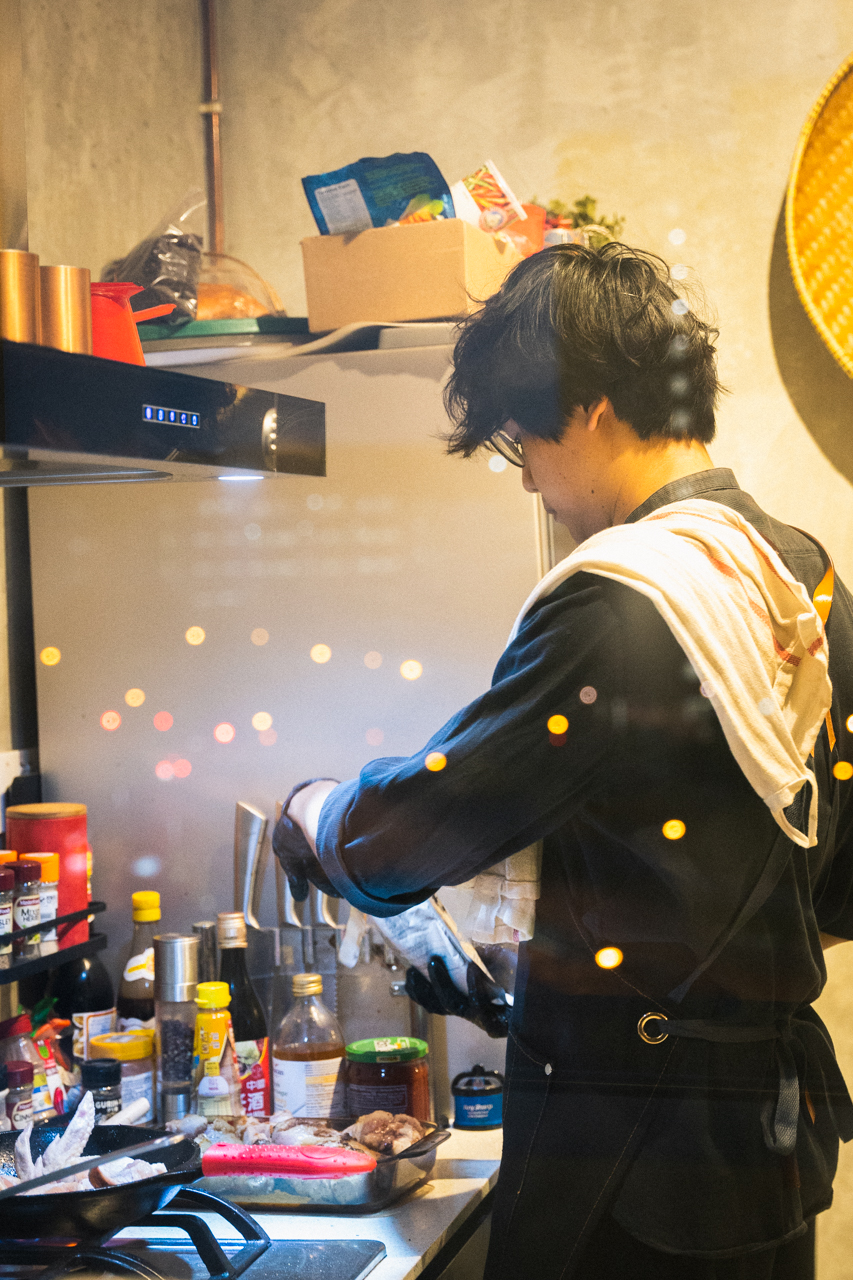 Ilyas preparing dishes in his kitchen.