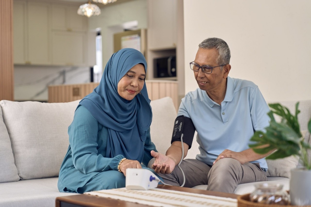 Senior couple taking blood pressure