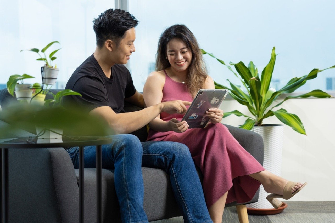 Young couple smiling as they plan finances together