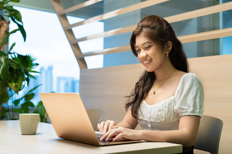 Lady smiling at laptop
