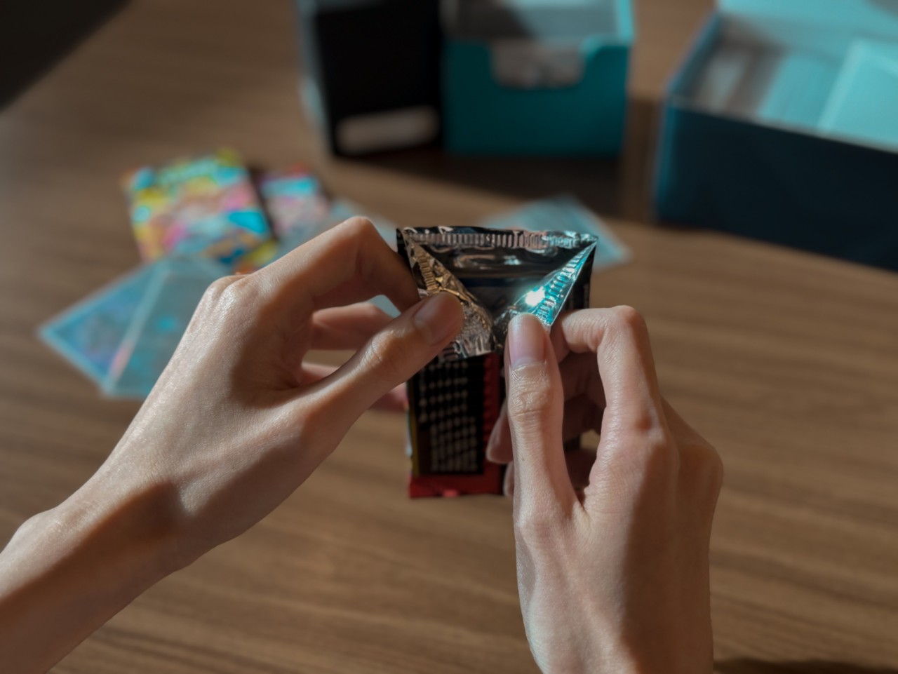 Person opening a pack of pokemon cards