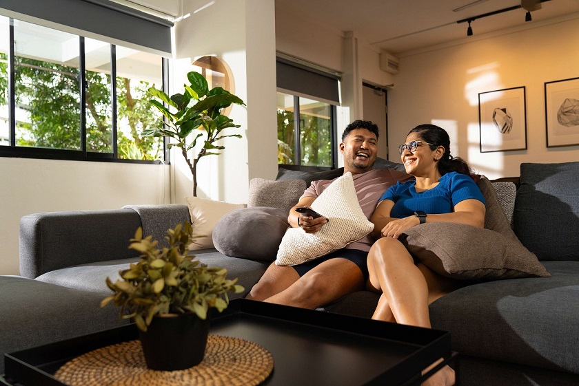 Couple sitting on sofa in living room