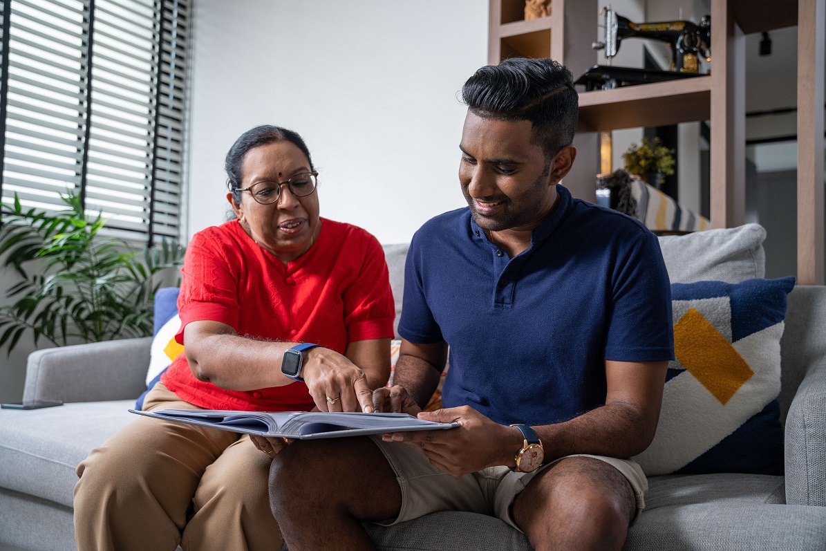Indian mother and son reviewing documents together