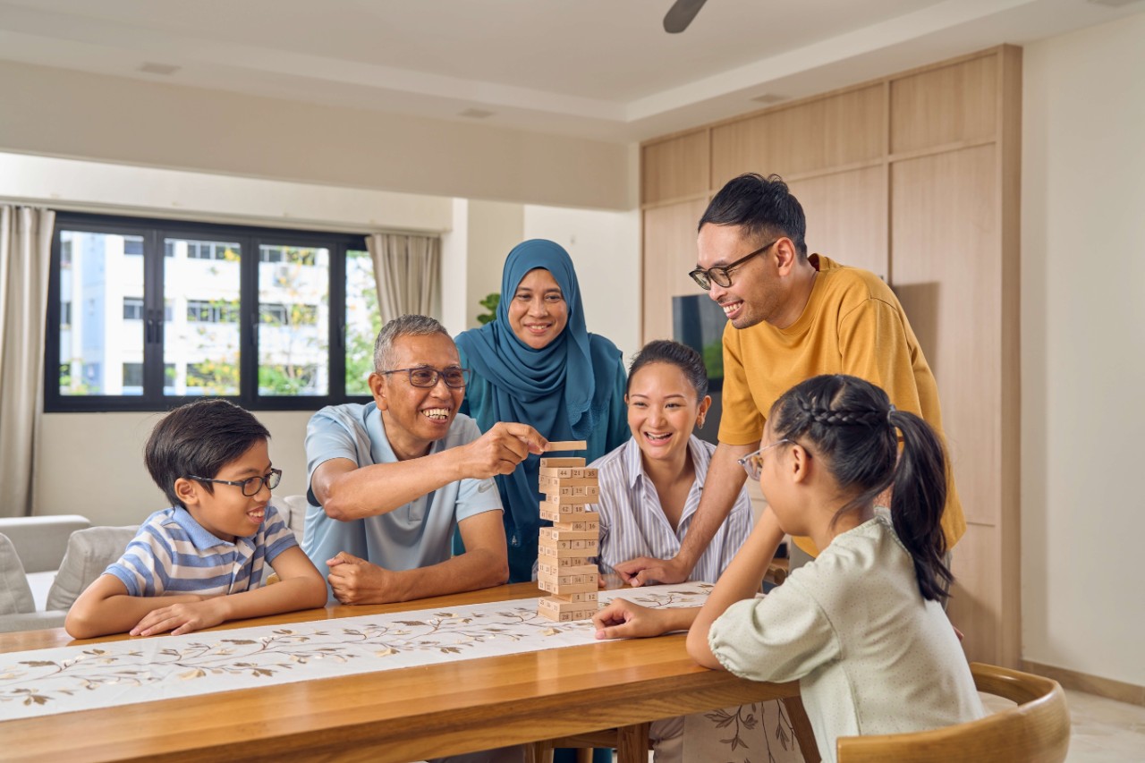 3 gen family playing a game together at home