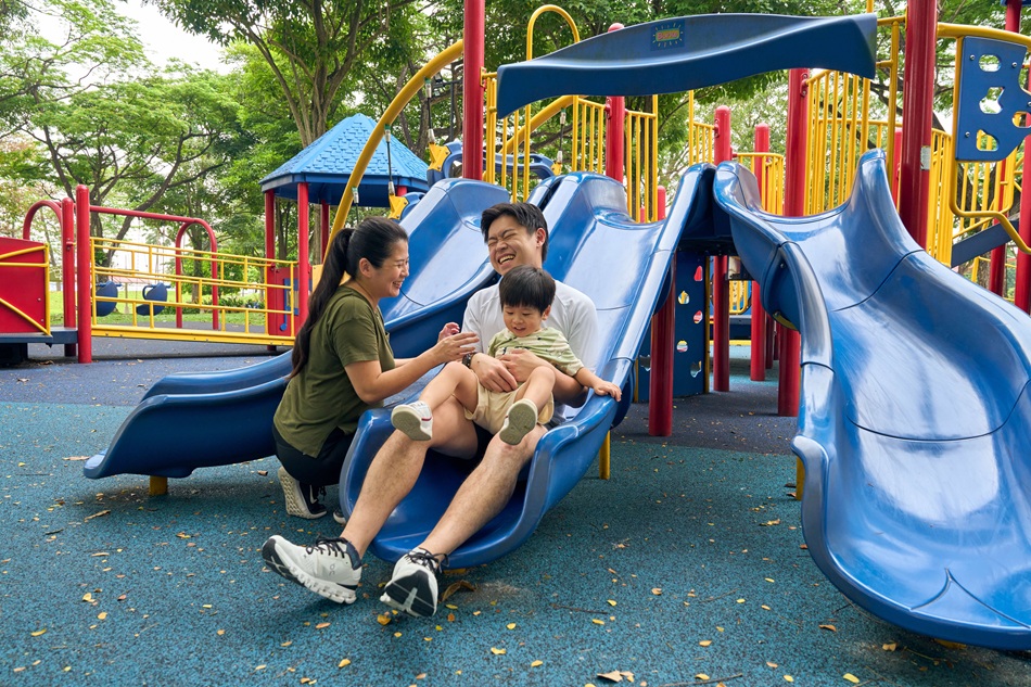 Young family playing together in the playground