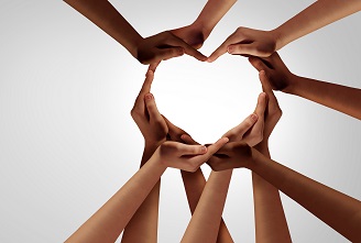 Unity and diversity partnership as heart hands in a group of diverse people connected together shaped as a support symbol expressing the feeling of teamwork and togetherness.
